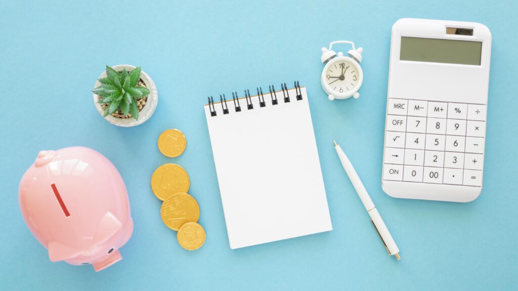 flat-lay-finance-elements-assortment-with-empty-notepad