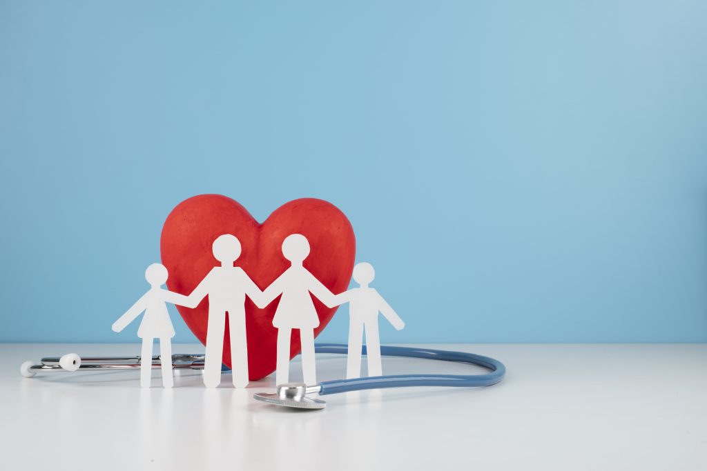 Family Health Insurance Cover in India – Paper Family with Heart and Stethoscope